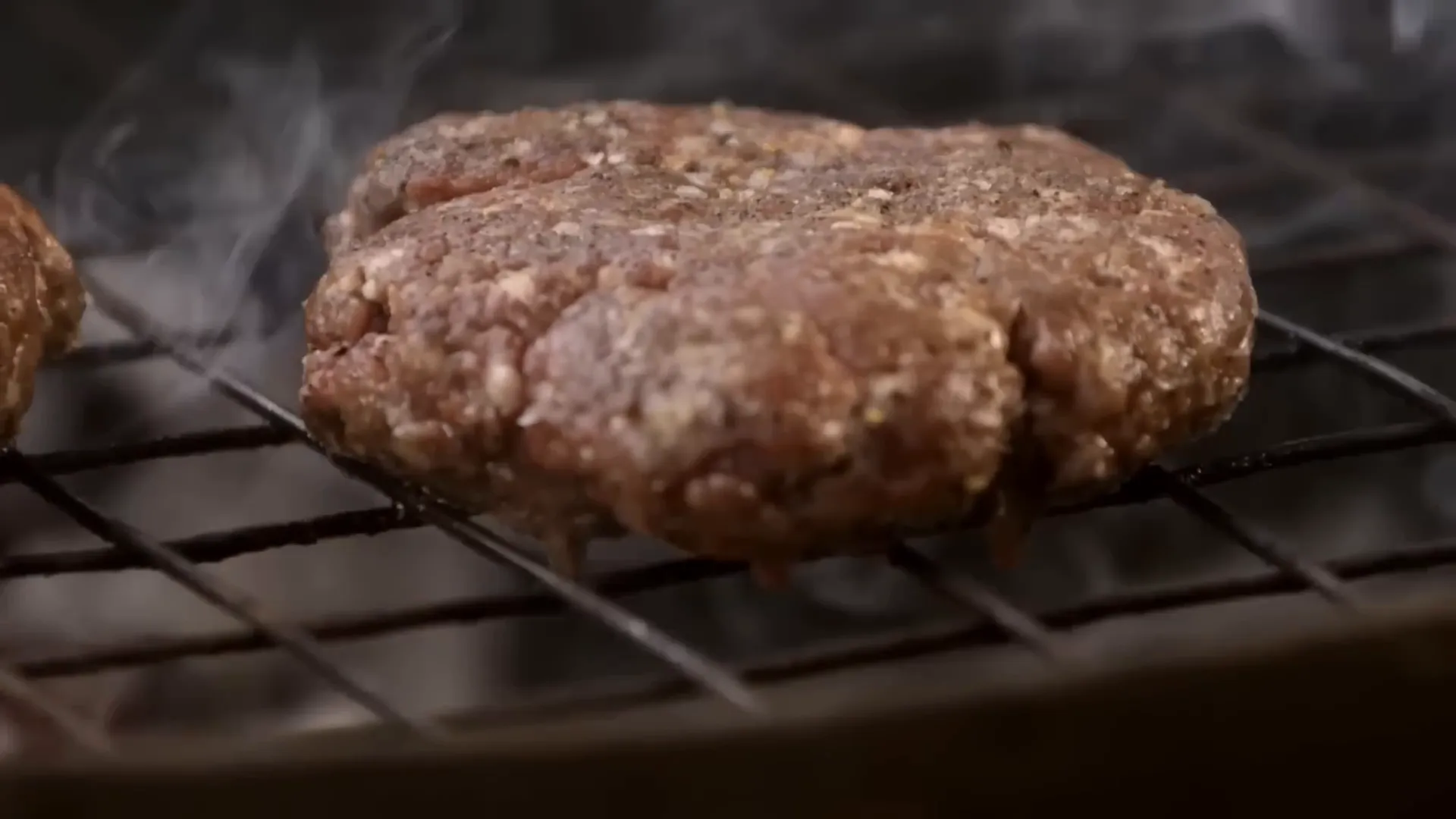 Juicy chuck steak burgers cooking on the barbecue