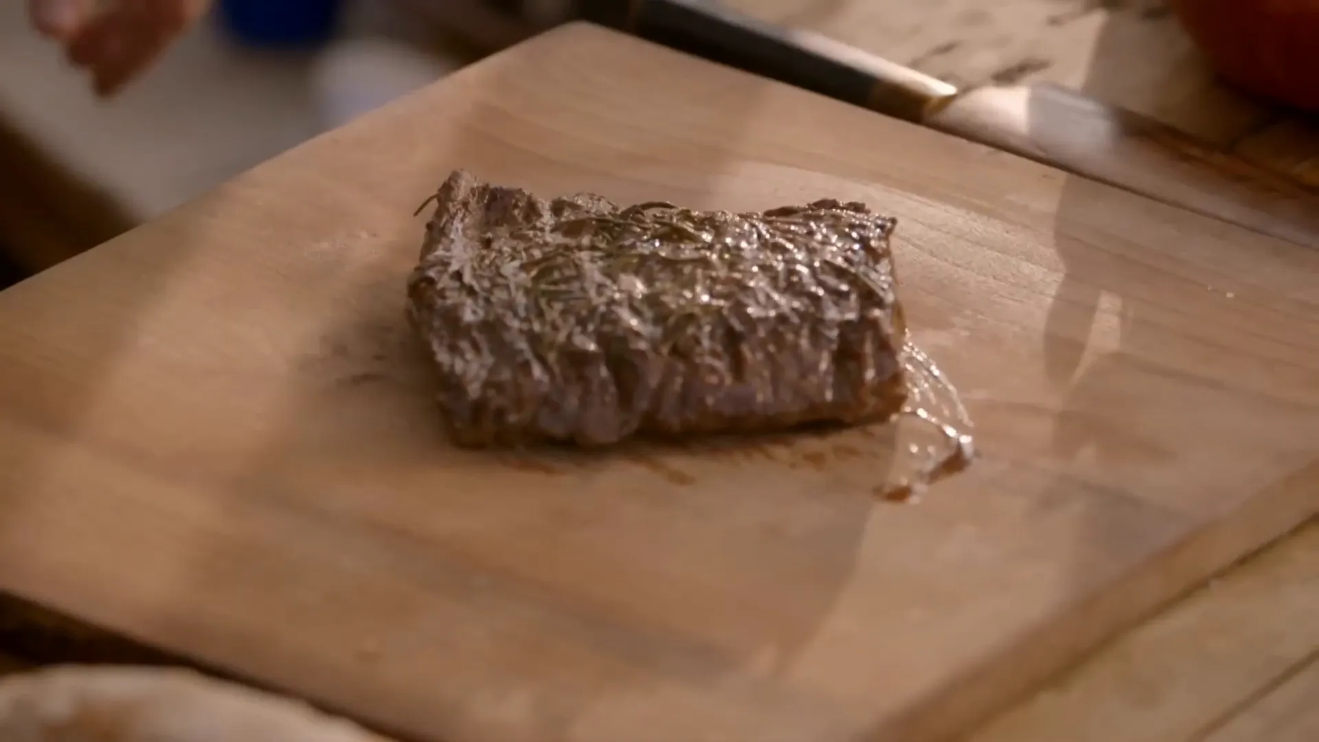 Slicing rested skirt steak against the grain for tenderness
