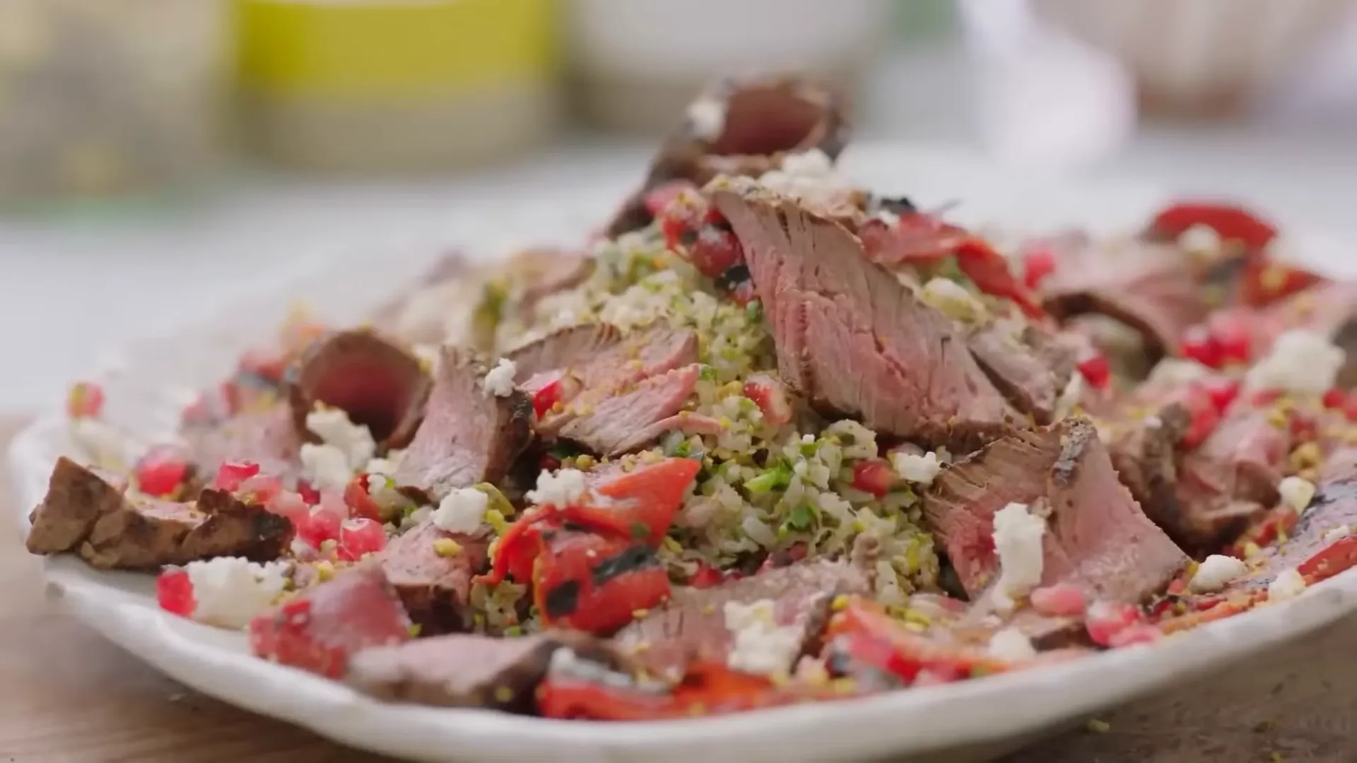 Resting steak on charred peppers with brown rice taboulet