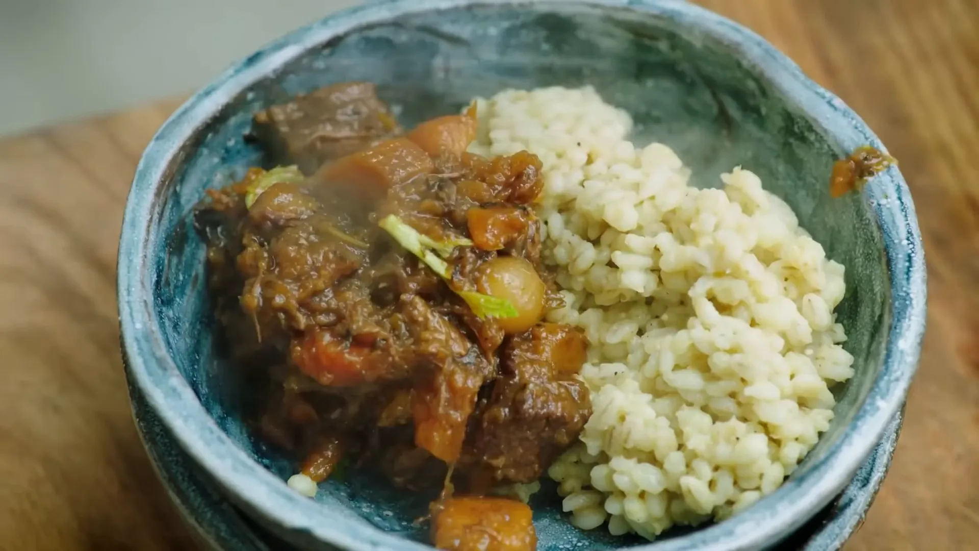 Hearty beef and Guinness stew with barley and steamed greens