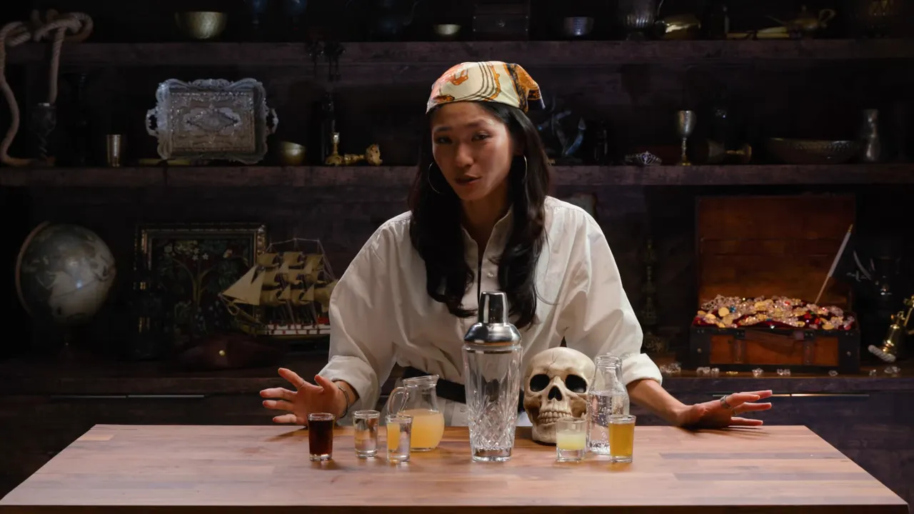 Cocktail shaker with rum being used to make grog