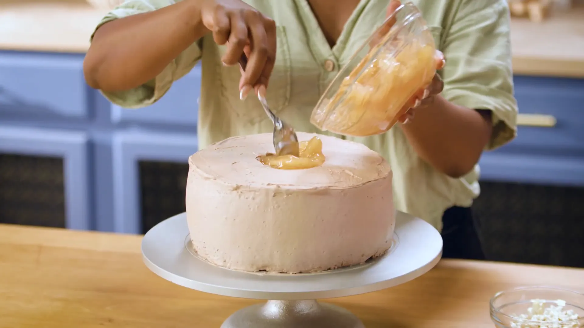 Adding canned apple pie filling to the cake