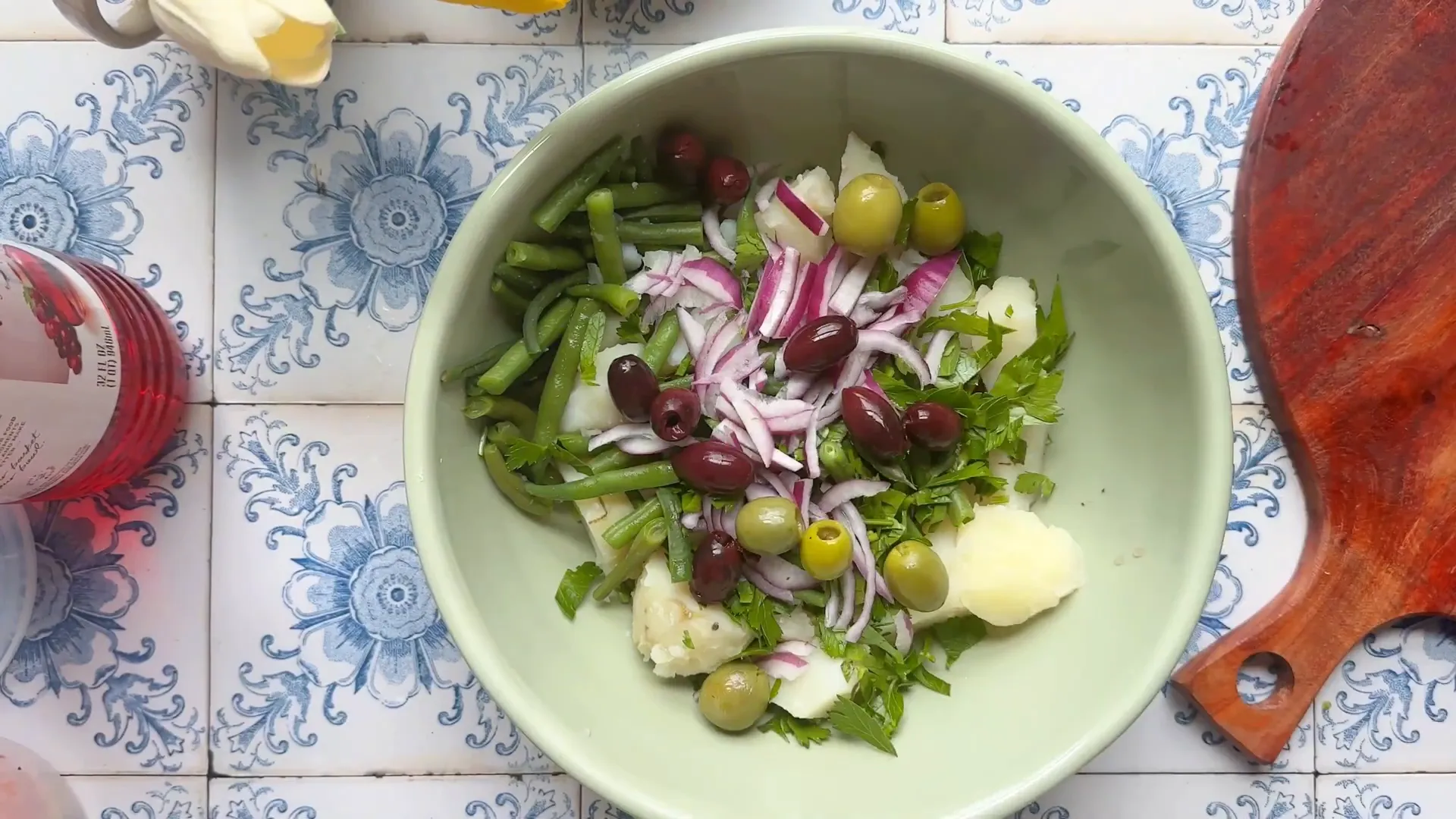 Bowl with potatoes, green beans, parsley, red onions, and Kalamata olives
