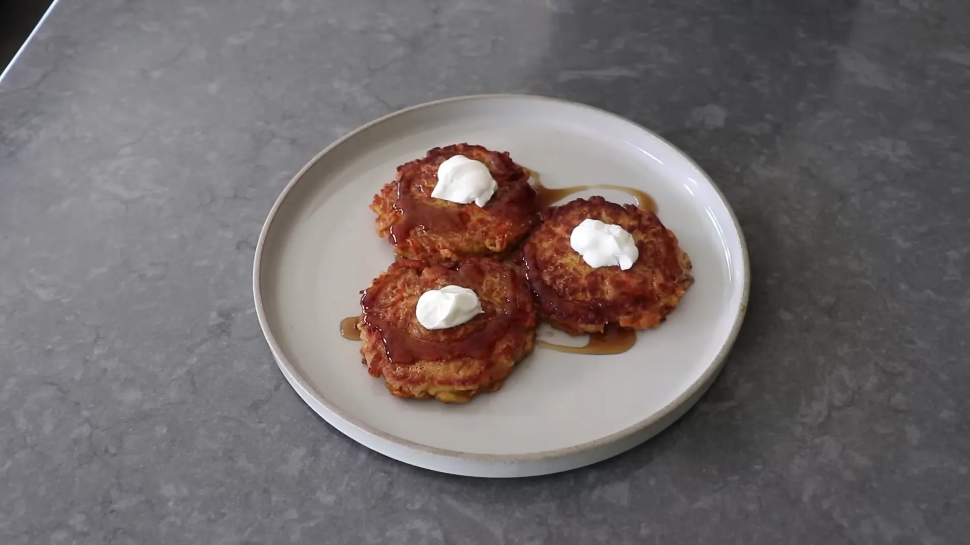 Plated carrot apple pancakes with yogurt and maple syrup