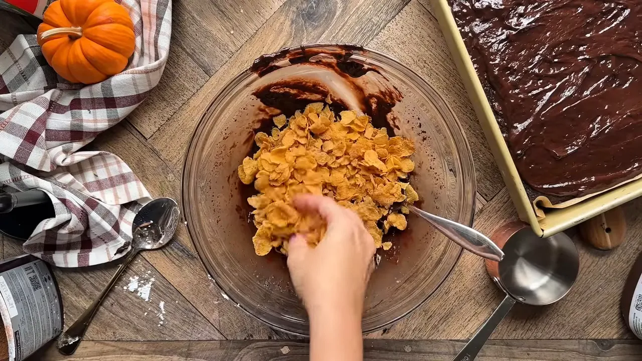Mixing corn flakes into the ganache to make crunchy clusters
