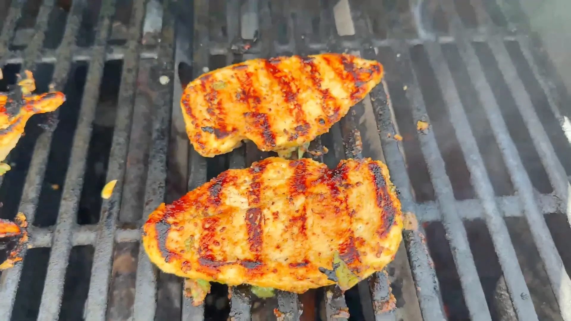 Grilled chicken breasts cooking on hot grill