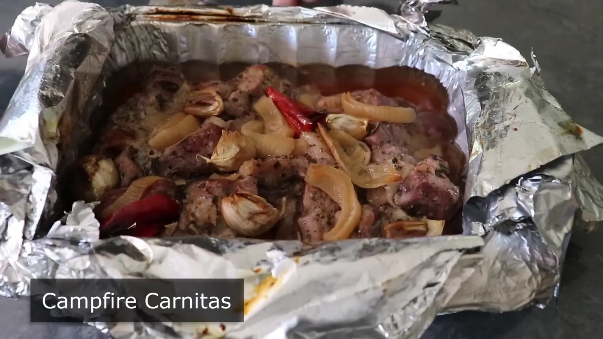 Boneless pork shoulder cut into chunks ready for campfire carnitas