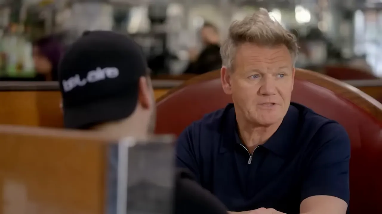 consultant giving advice to a restaurant owner in a booth, clear lighting and composition