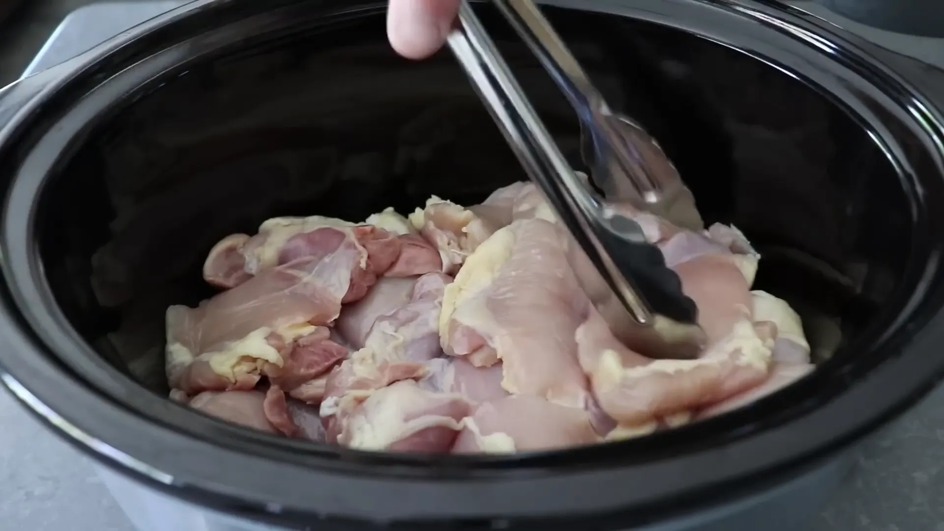 Boneless skinless chicken thighs placed in the slow cooker