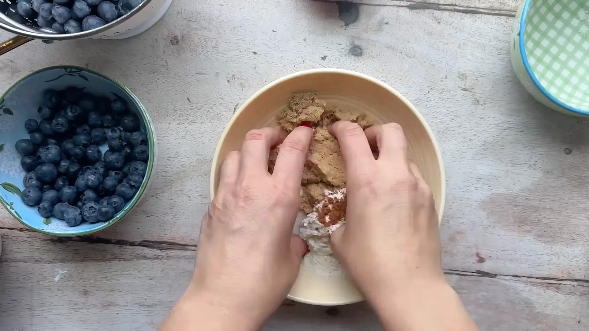 Mixing crumble topping ingredients with cold butter