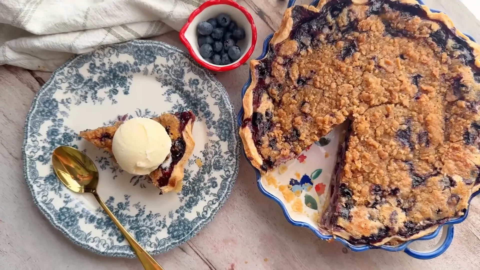 Slice of blueberry custard pie served with vanilla ice cream