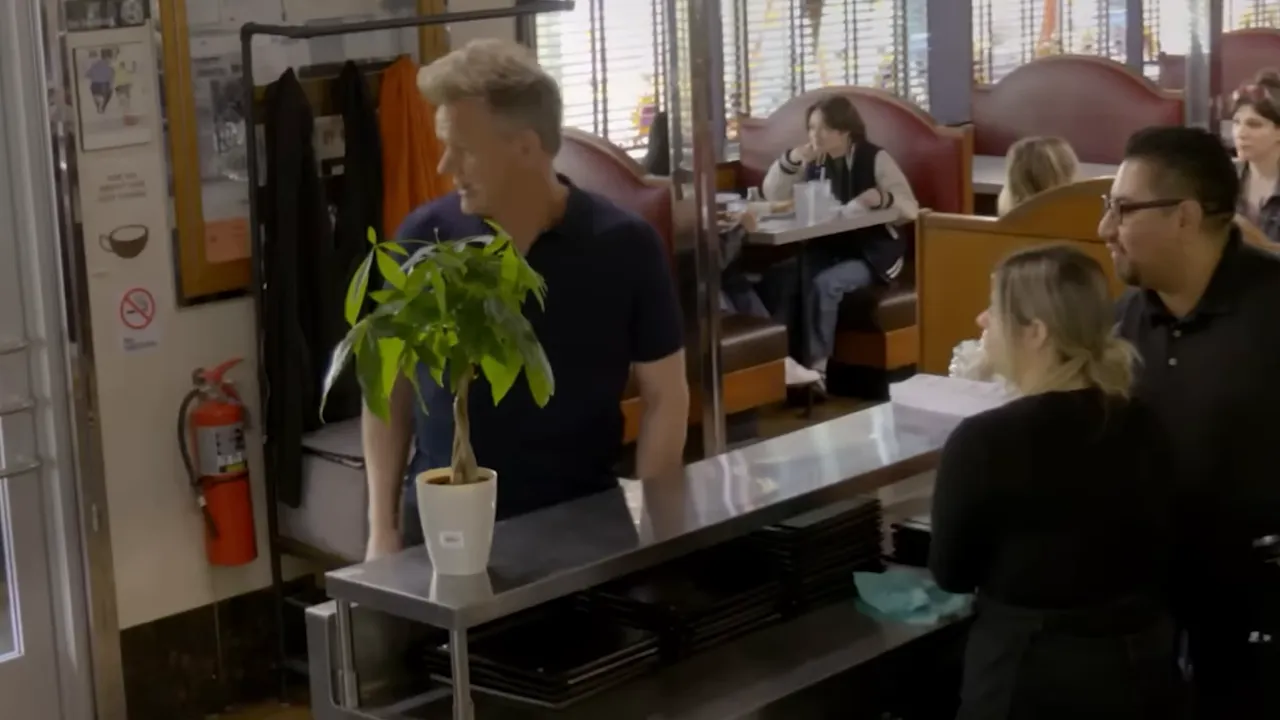 overhead view of a diner's front counter and host station with booths and staff