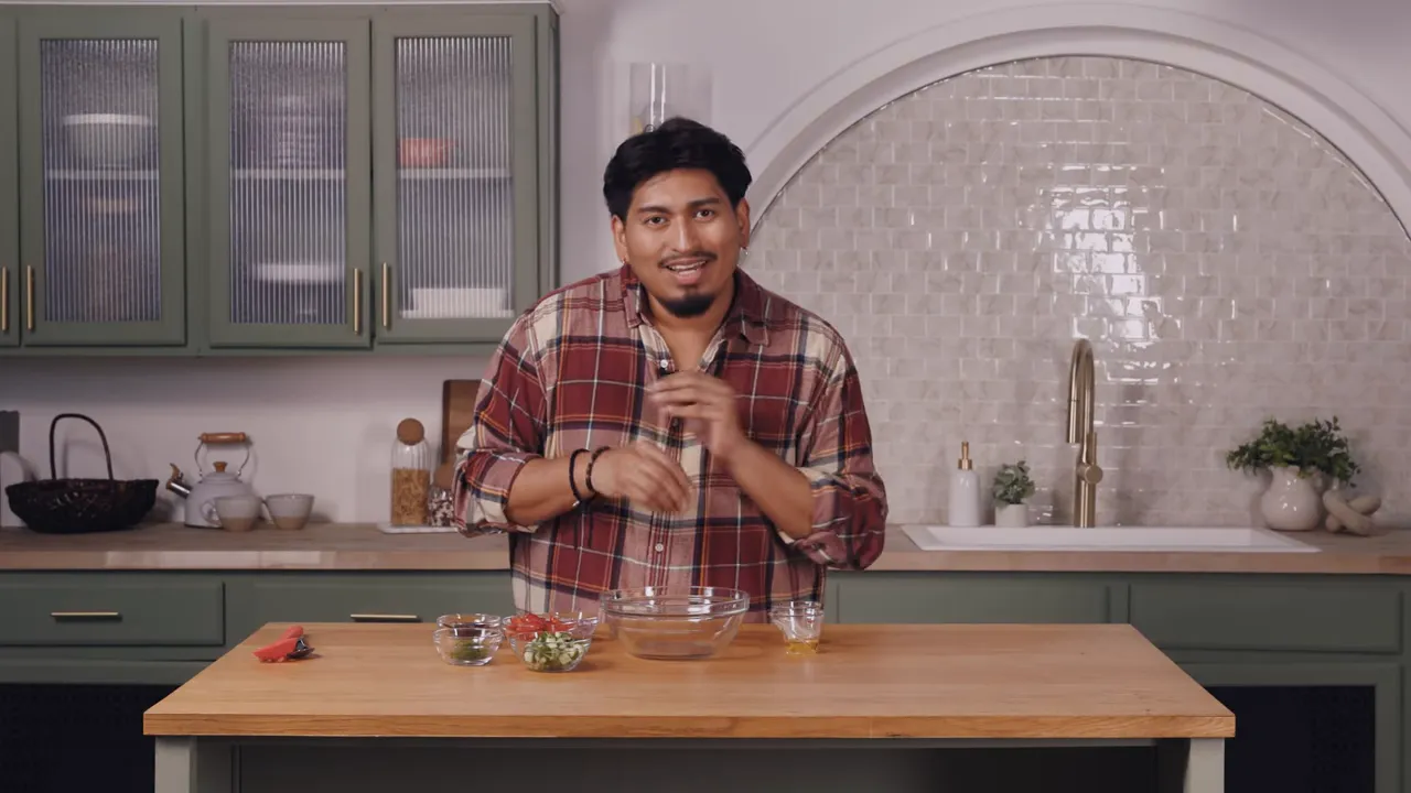 Host at a kitchen island with bowls of ingredients ready to mix for a salmon bowl.