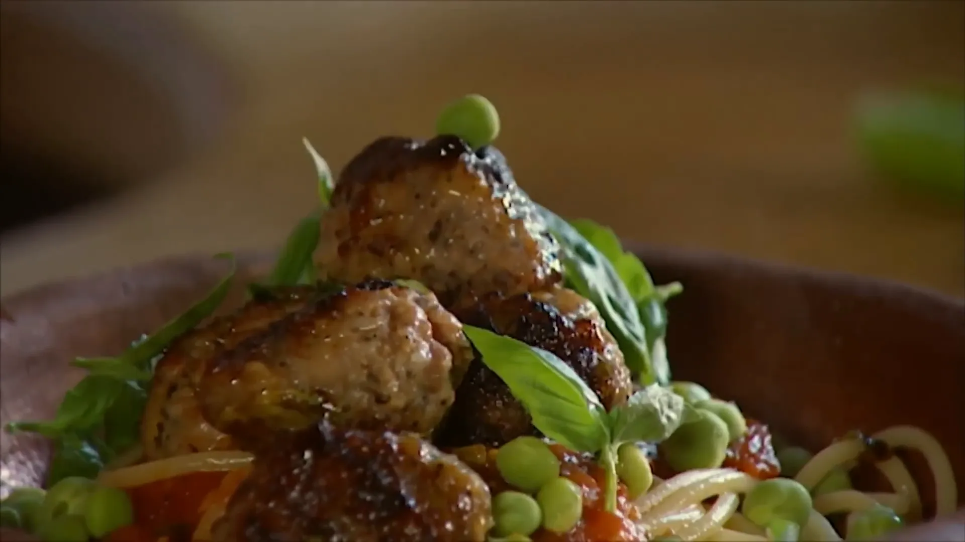 Rustic meatballs with spaghetti and fresh peas