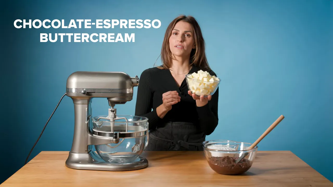 Kitchen scene with a stand mixer, bowl of cubed butter, a bowl of chocolate batter and on-screen text 'CHOCOLATE-ESPRESSO BUTTERCREAM'