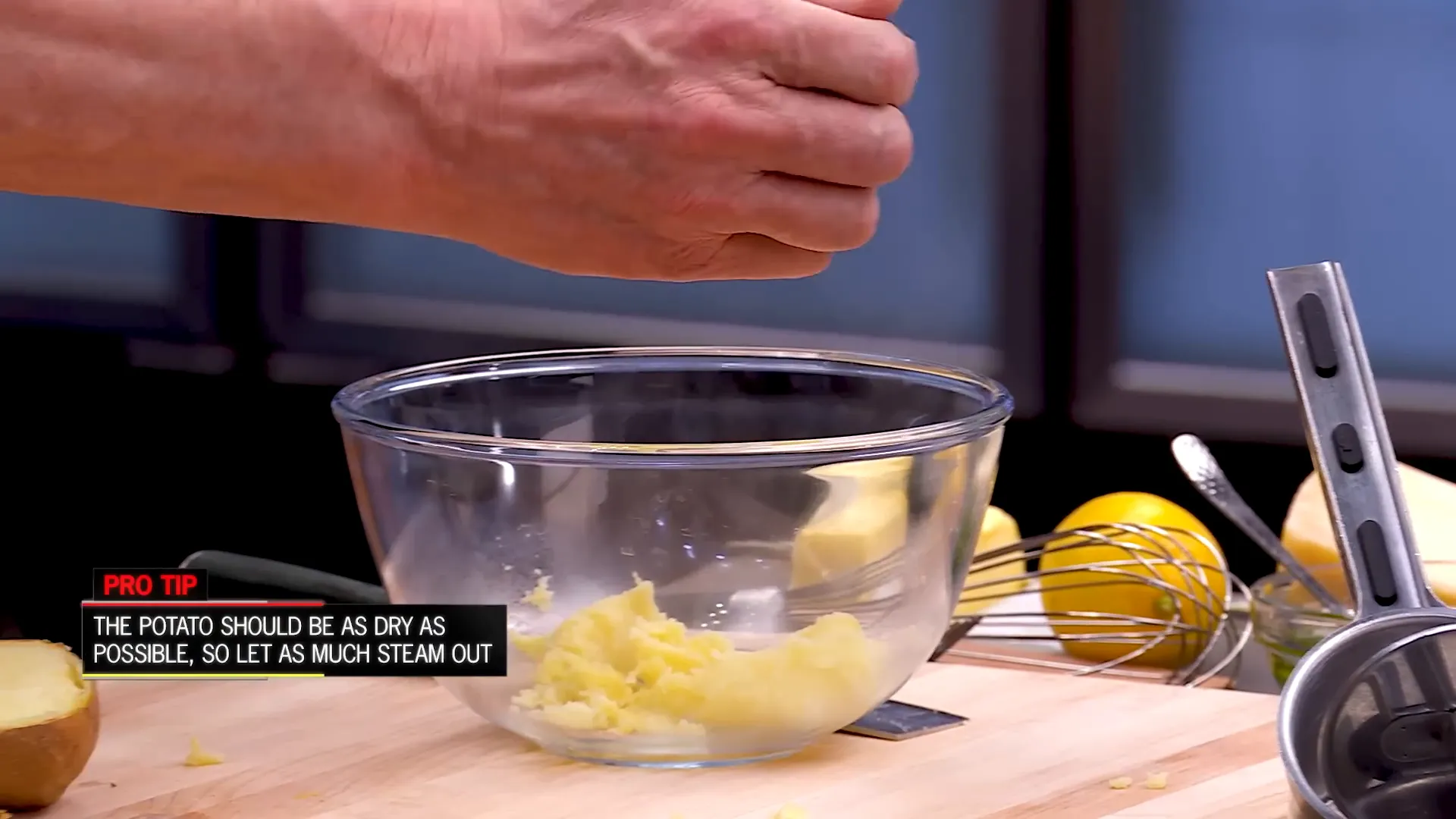 Potatoes being pushed through a ricer