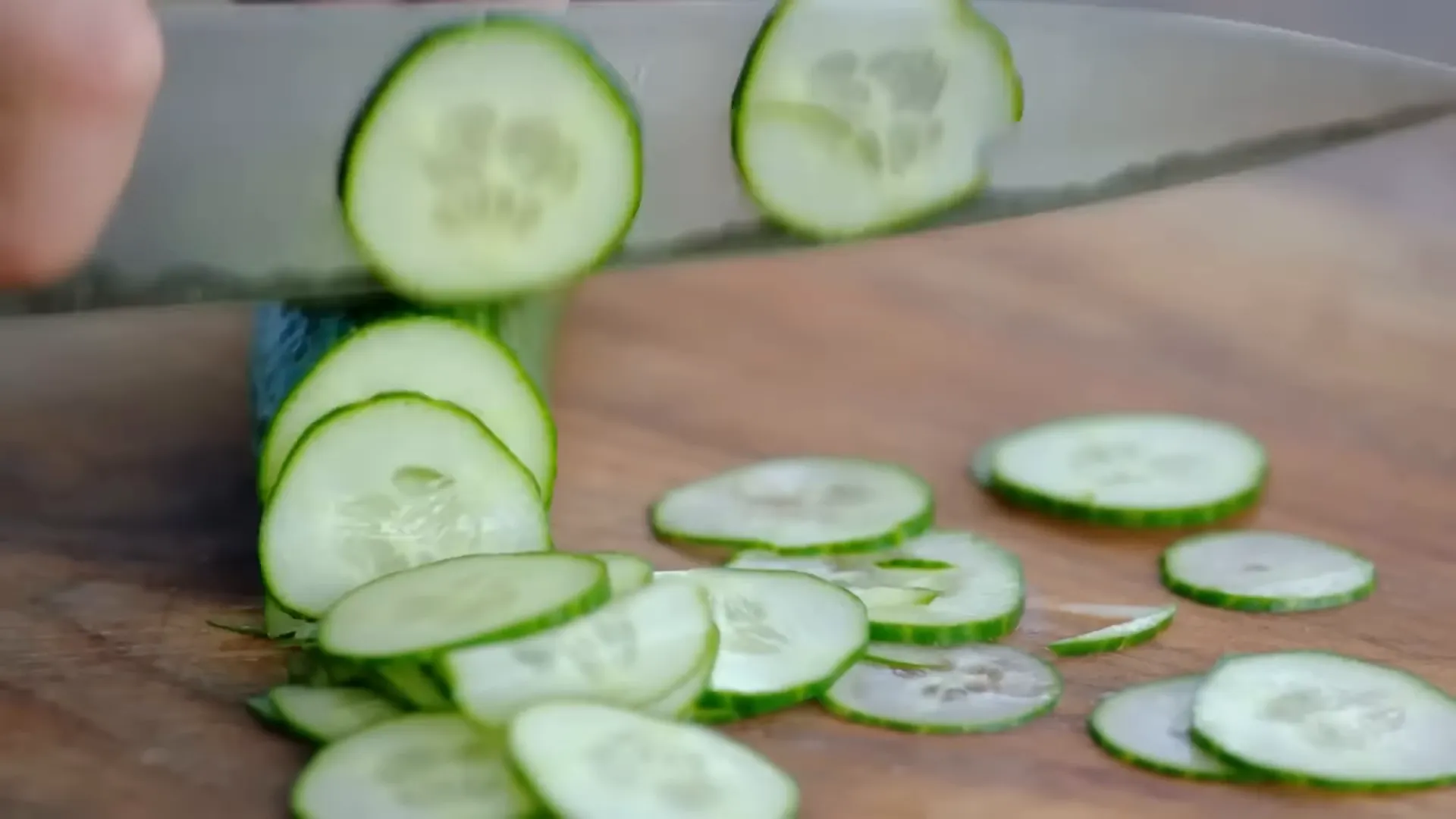 Quick cucumber pickle being massaged with salt and lime