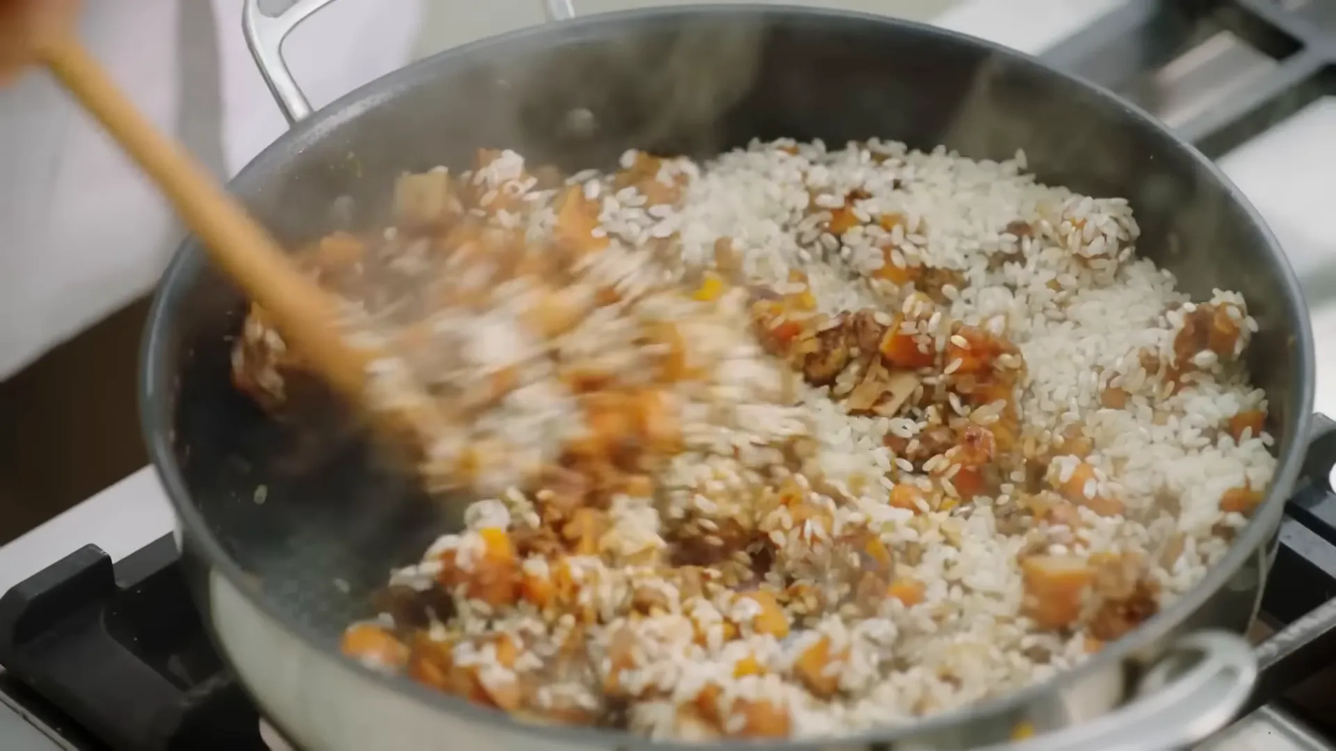 Arborio risotto rice being stirred in