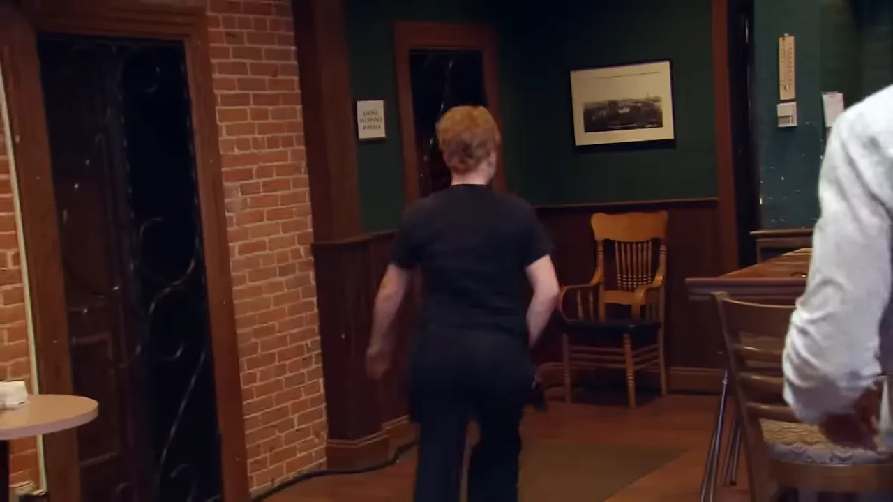 A tense staff meeting where the long-time manager decides to walk out