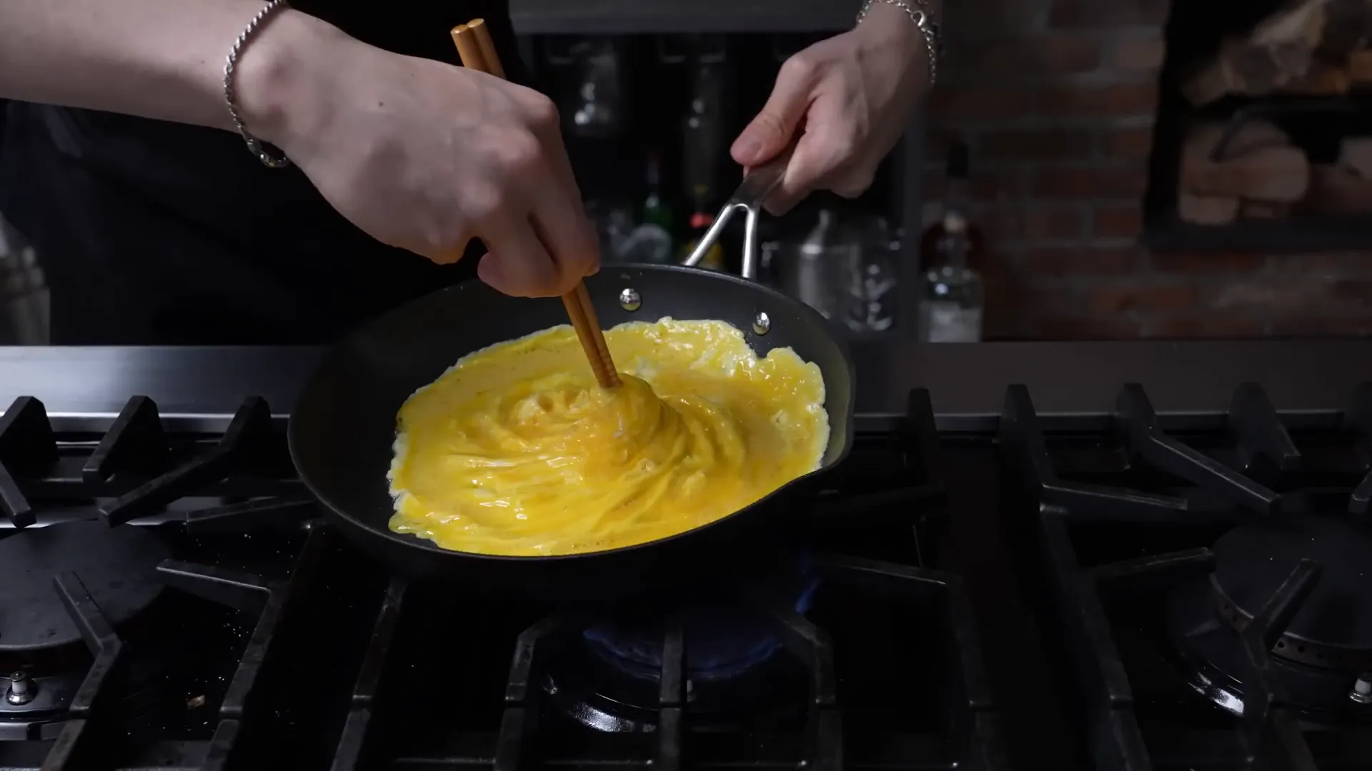 Tornado-style egg being twirled into a vortex in the pan