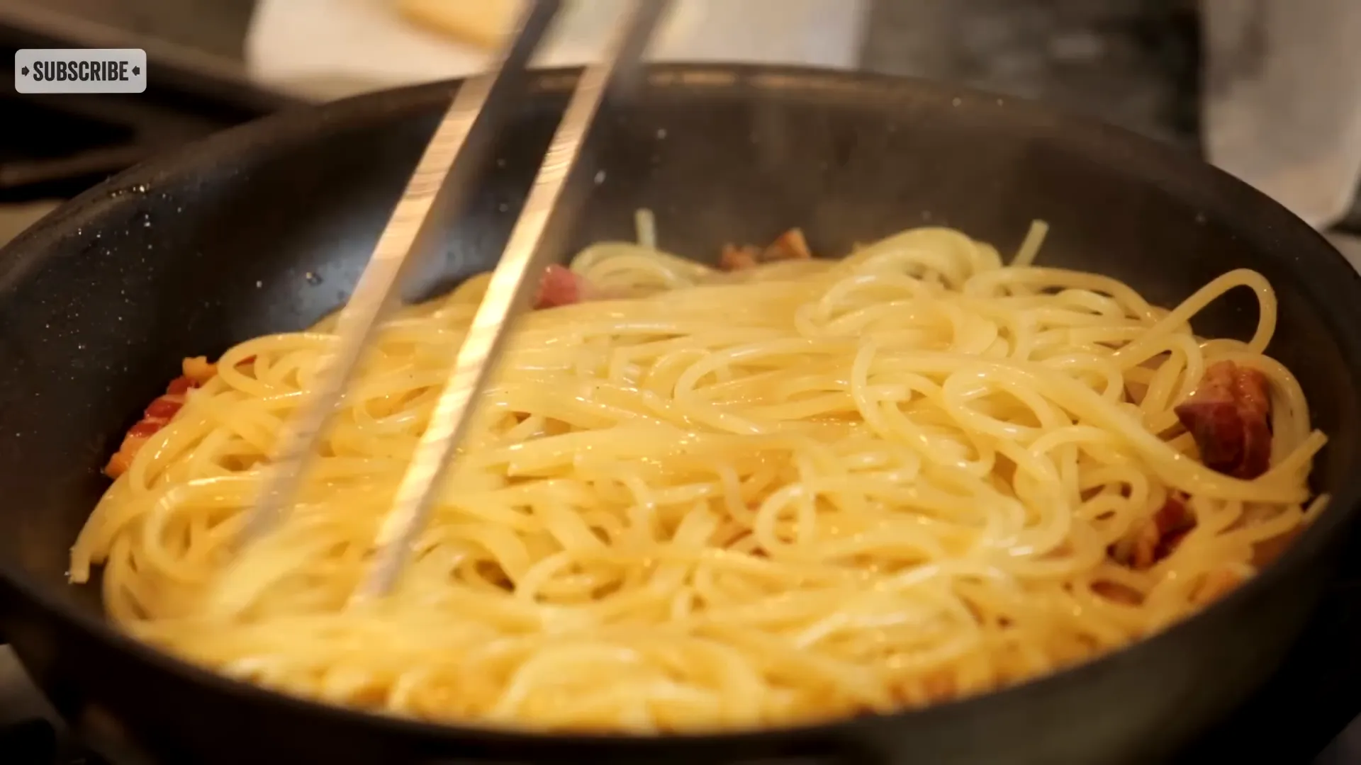 Tossing pasta with guanciale and sauce off the heat