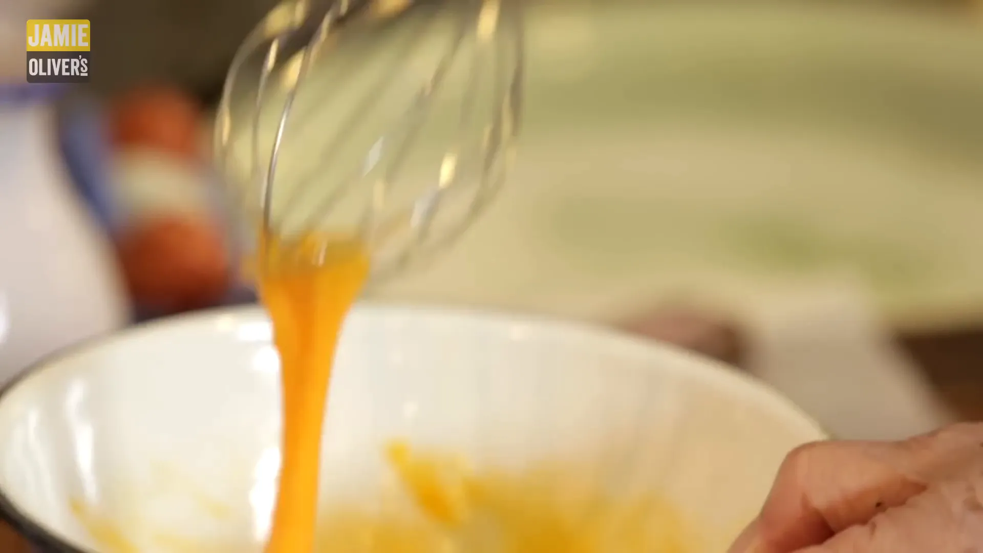Fresh egg yolks being beaten for the sauce