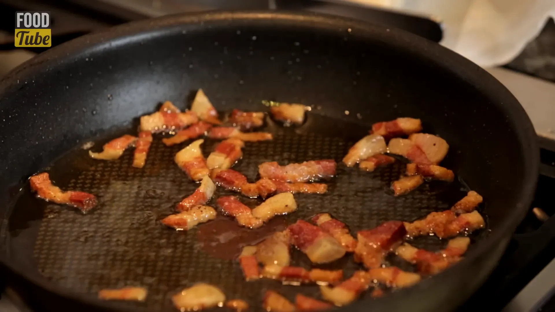 Guanciale cooking in olive oil in the pan