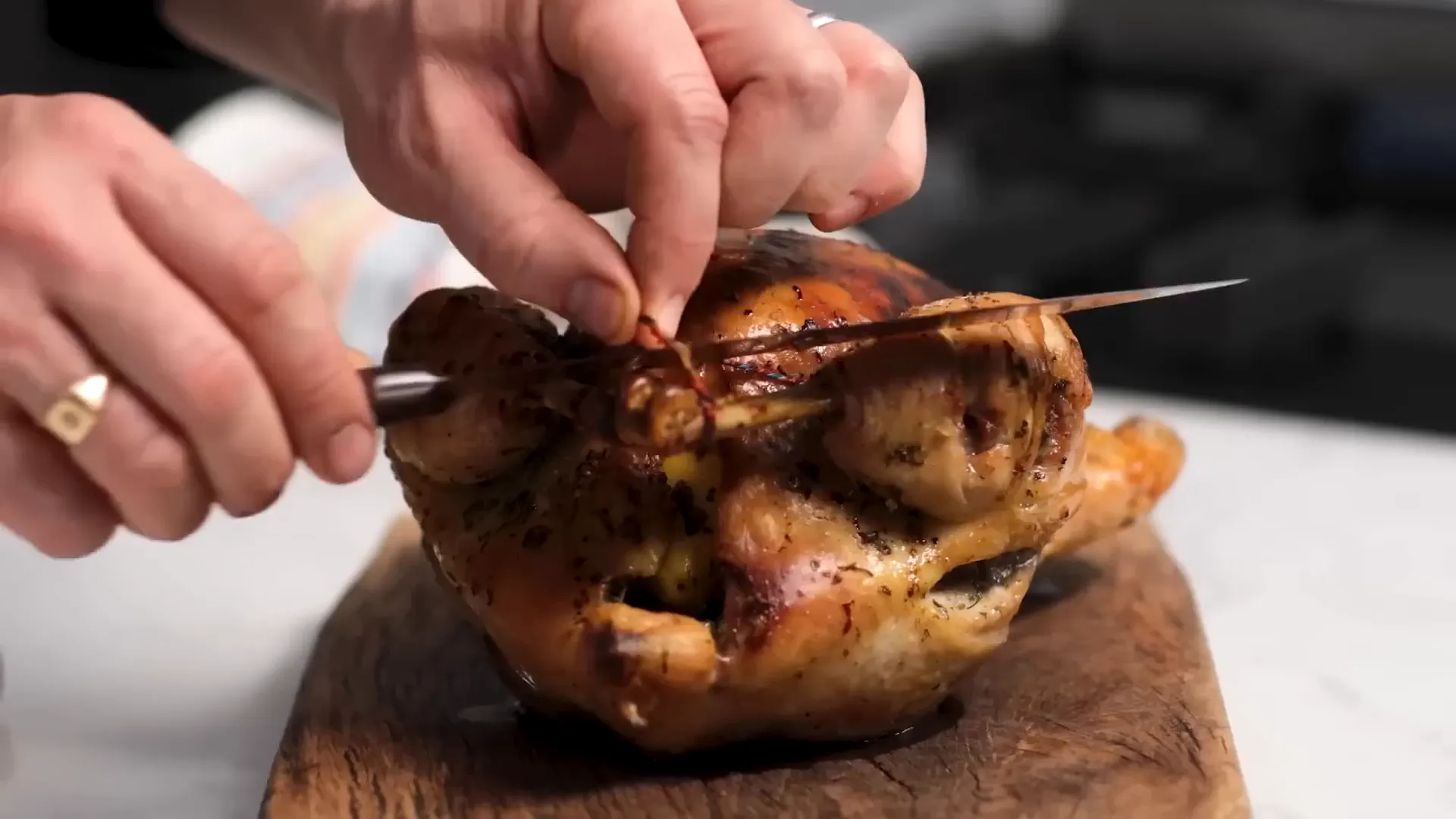 Carving juicy roast chicken with crispy skin