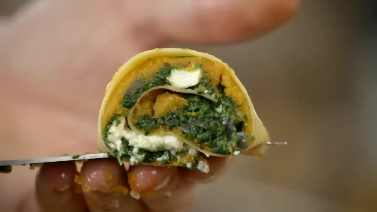 close-up cross-section of a squash and spinach rotolo showing layered filling