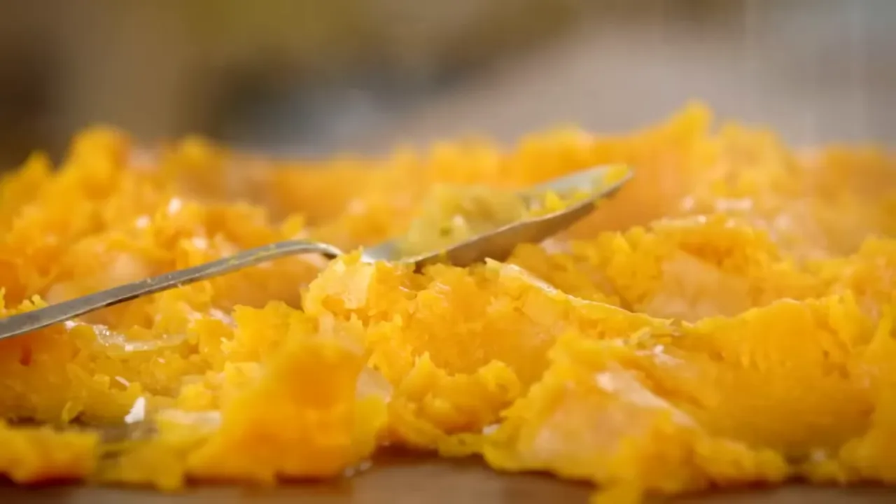 Close-up of mashed roasted squash with a spoon