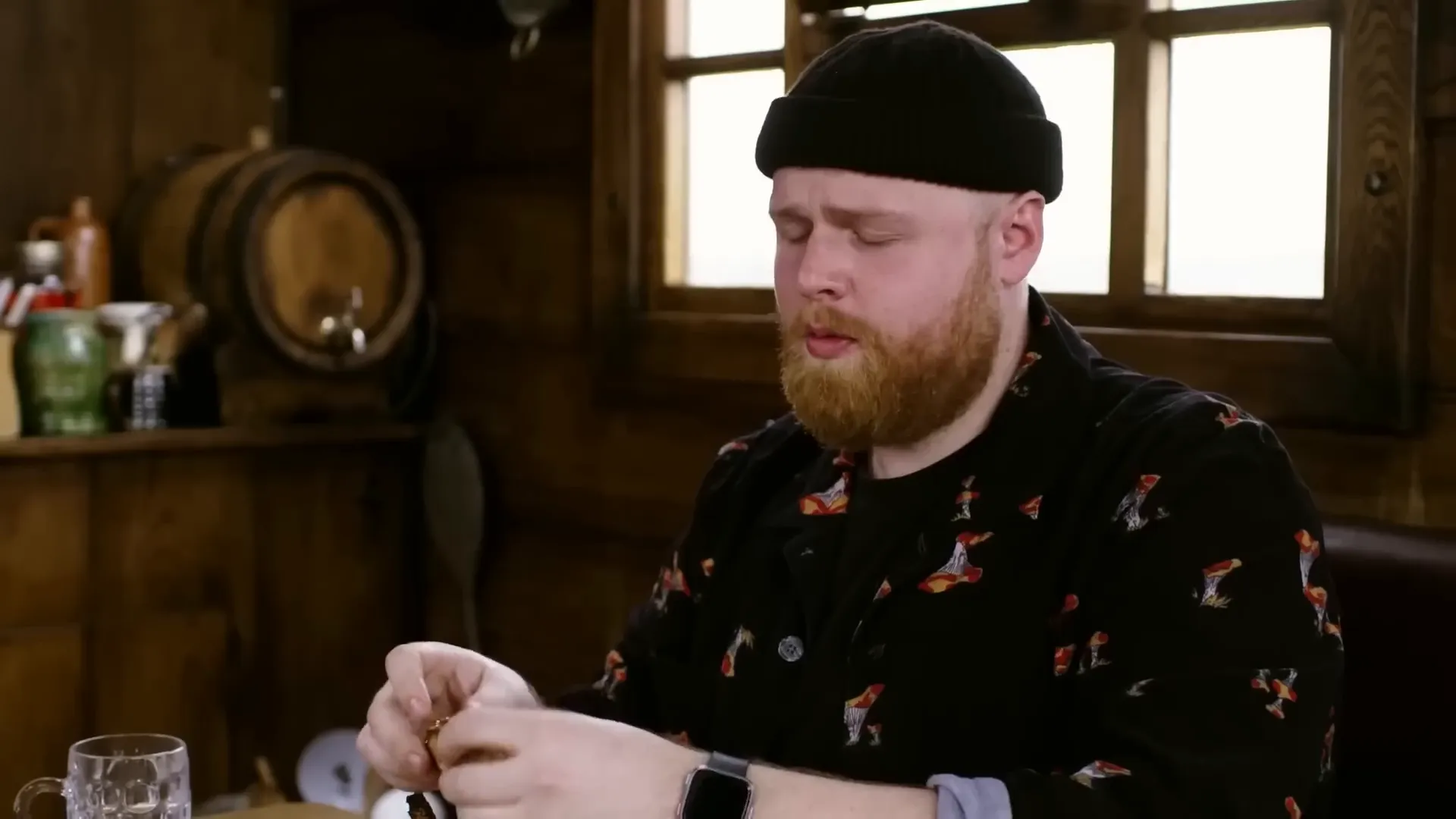 Tom Walker tasting the first hot sauce with a cautious expression