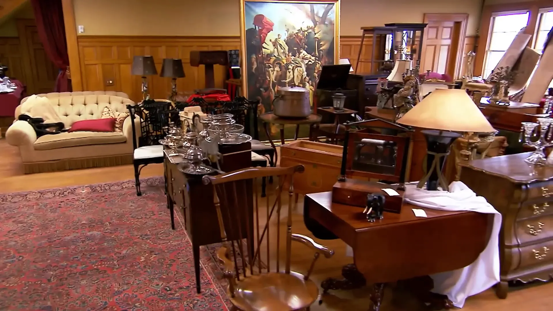 Room full of antiques and paintings at Juniper Hill Inn