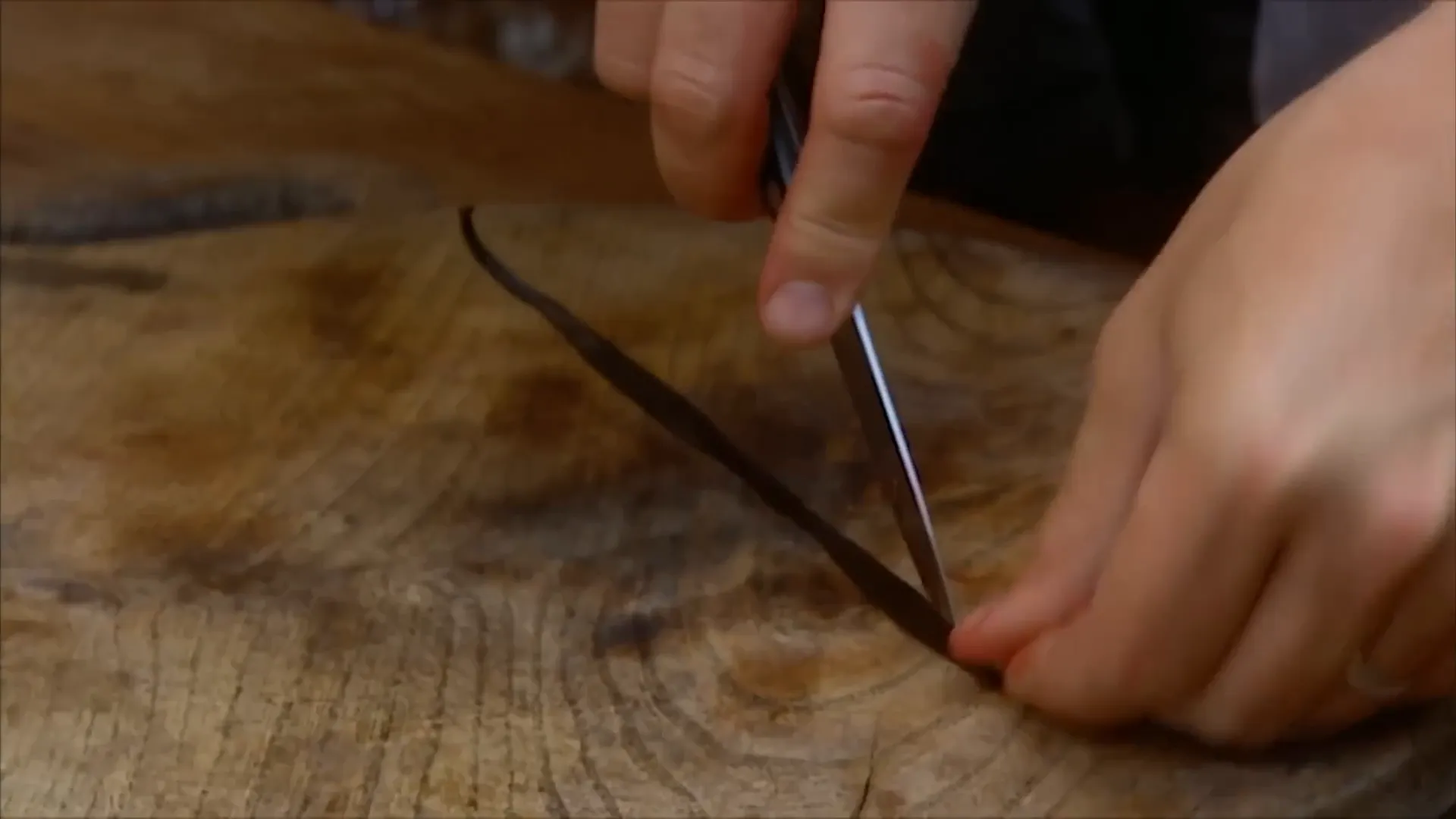 Vanilla bean being scraped to extract seeds