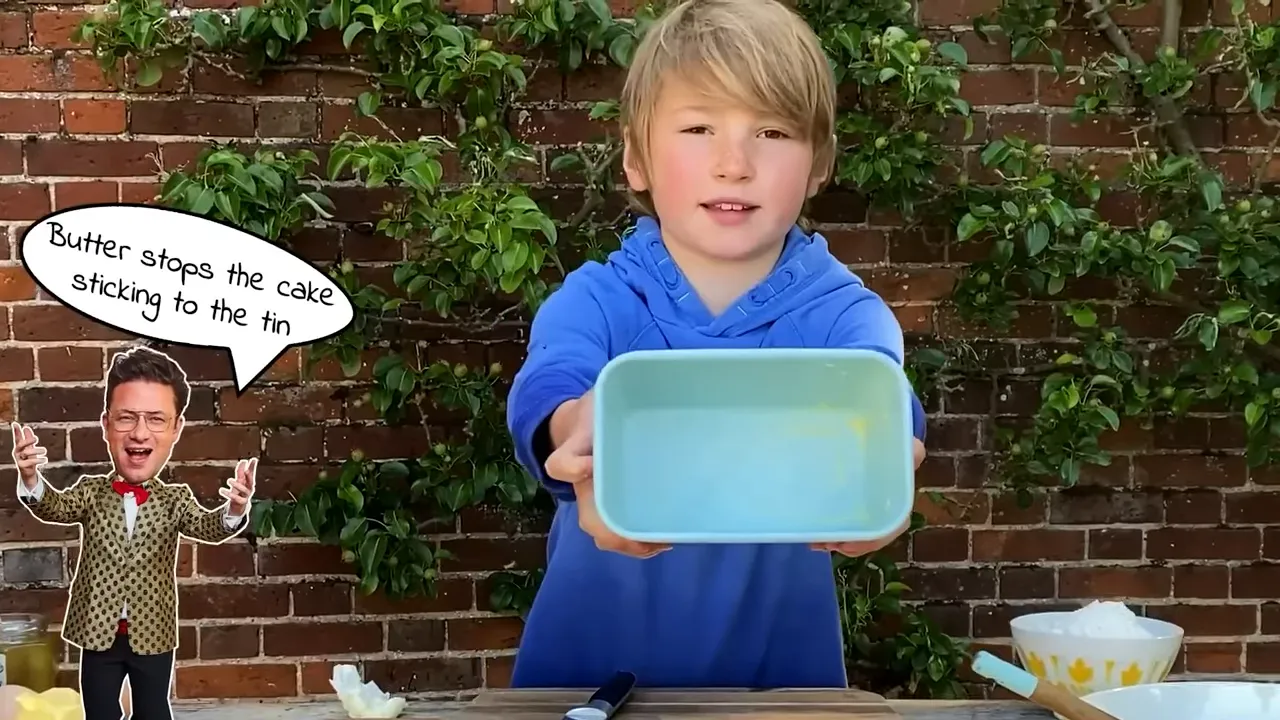 Child holding a greased blue loaf tin towards the camera, ready for batter