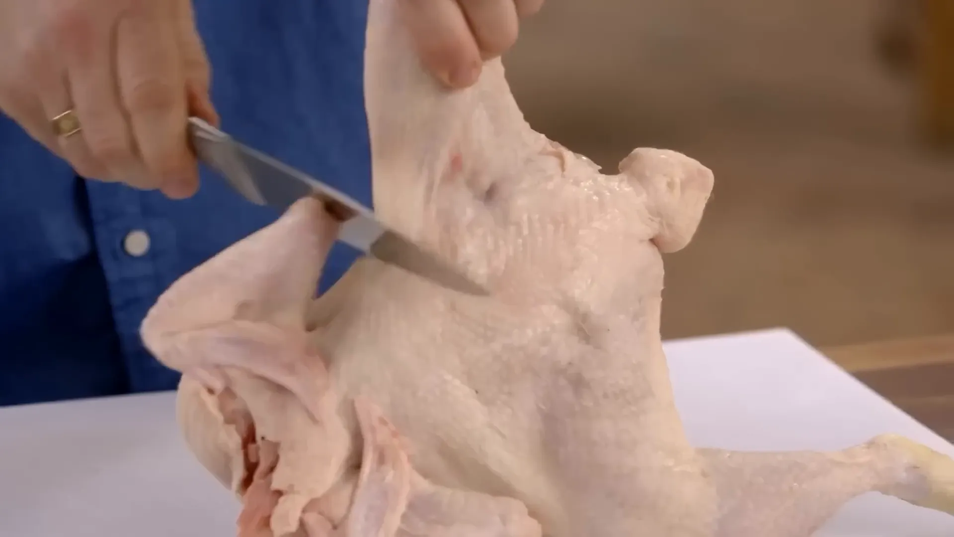 Whole chicken on a board, ready to joint