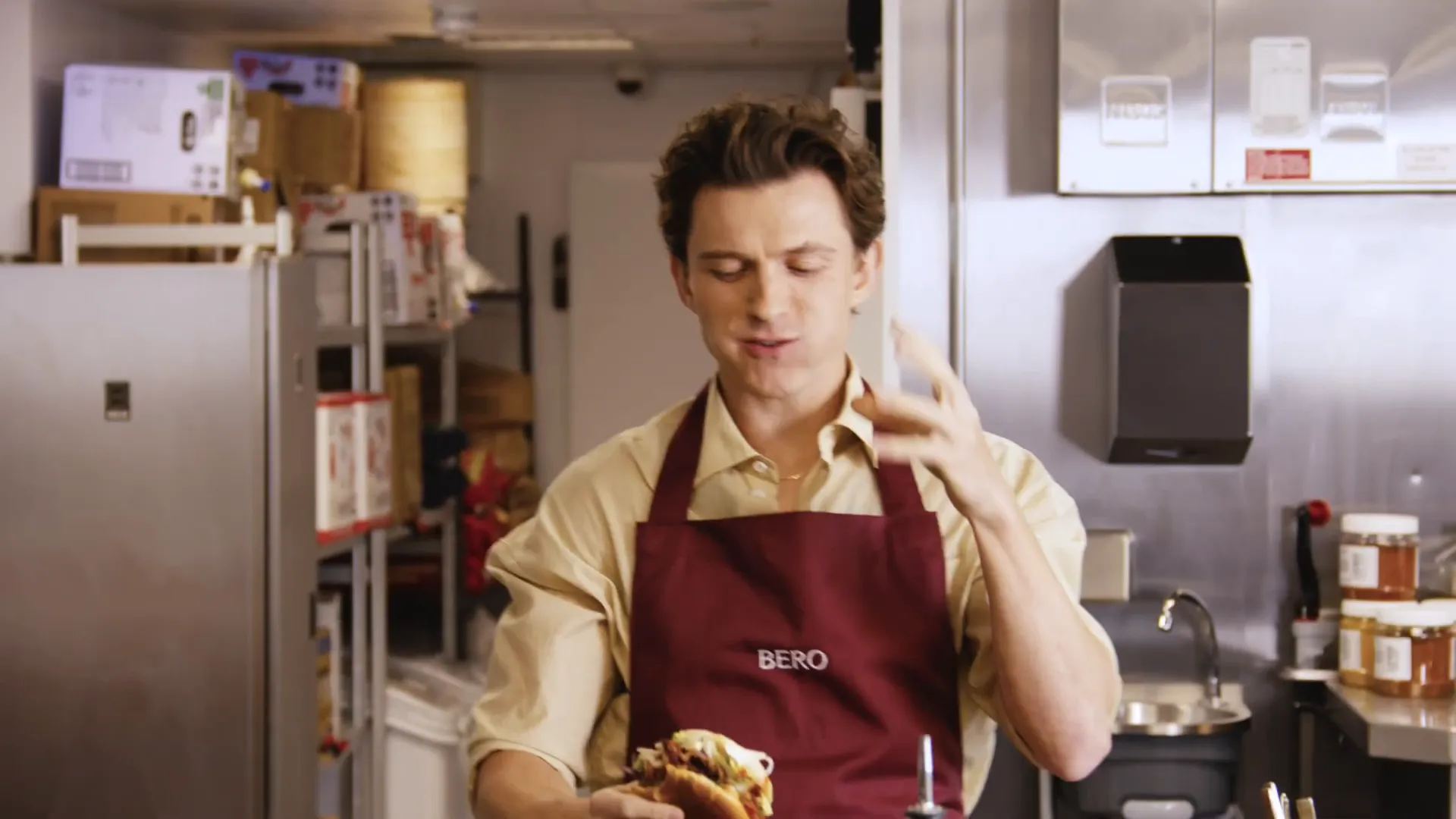 Tom Holland tasting the spicy fried chicken sandwich