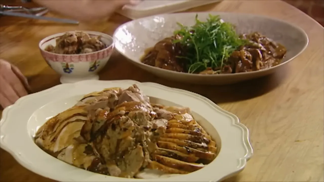 platter of carved turkey with gravy and side dishes ready to serve