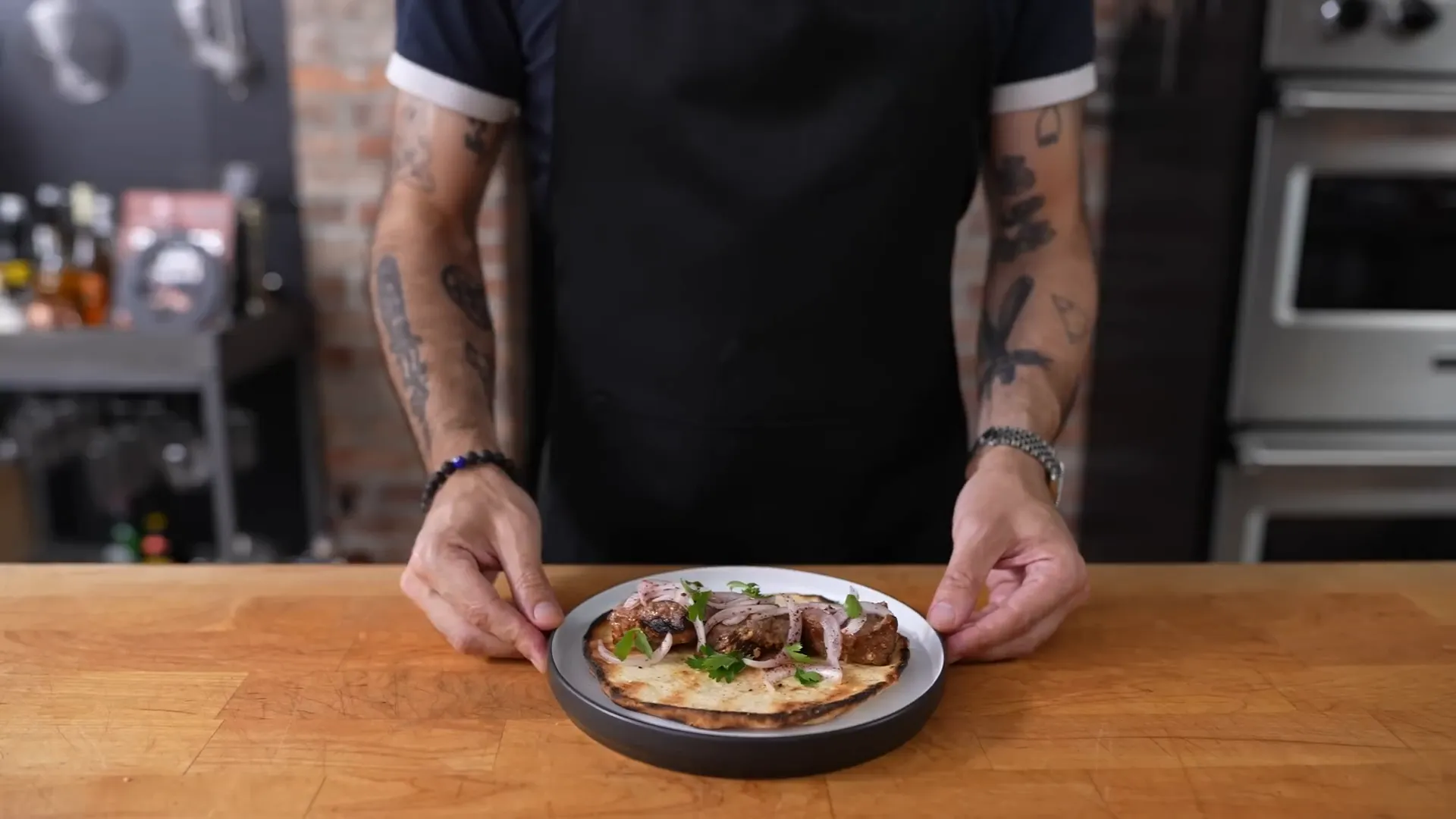 Turkish shish kebab on pita with garnishes