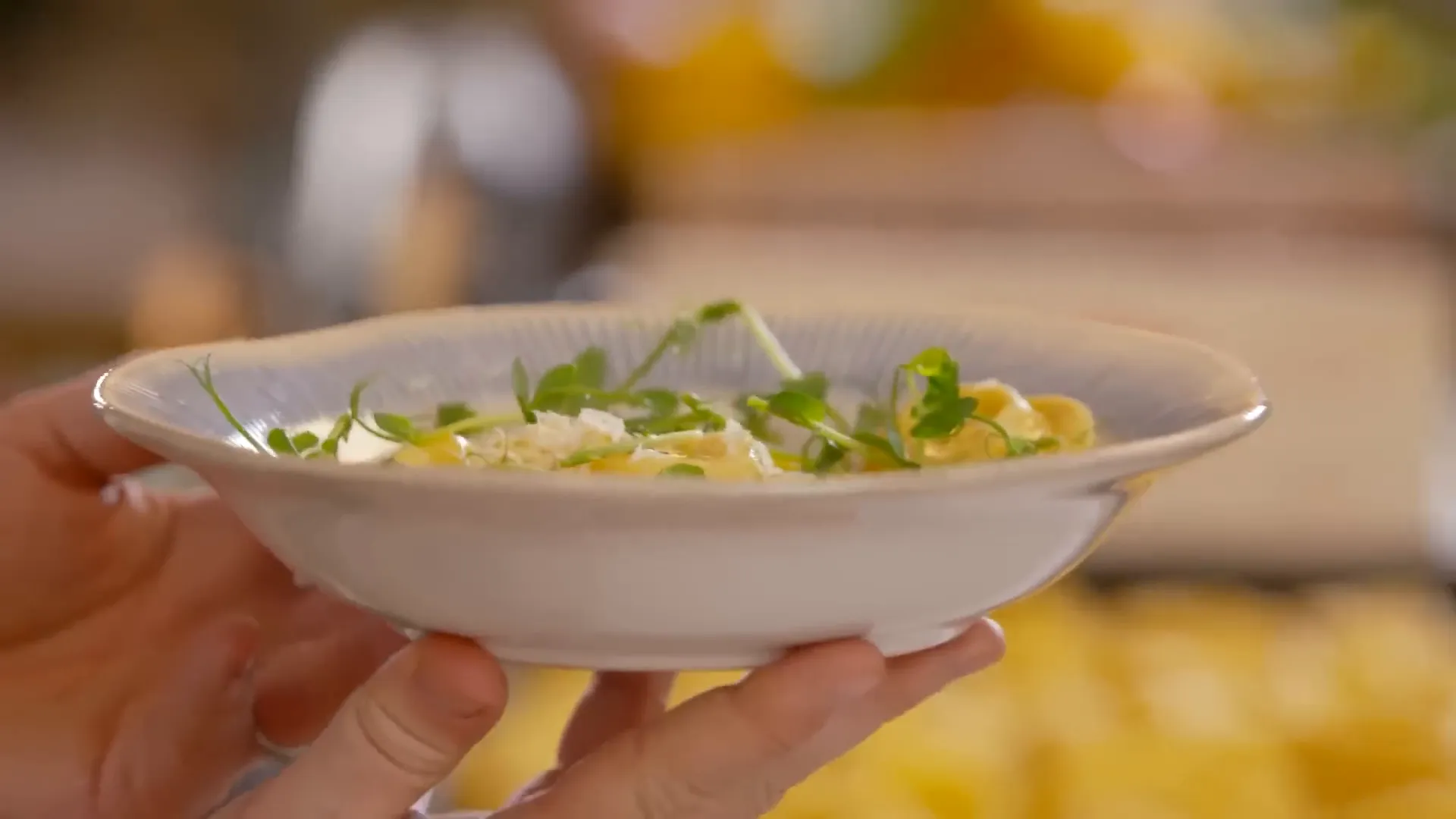 Finished white asparagus tortellini with pea shoots and parmesan