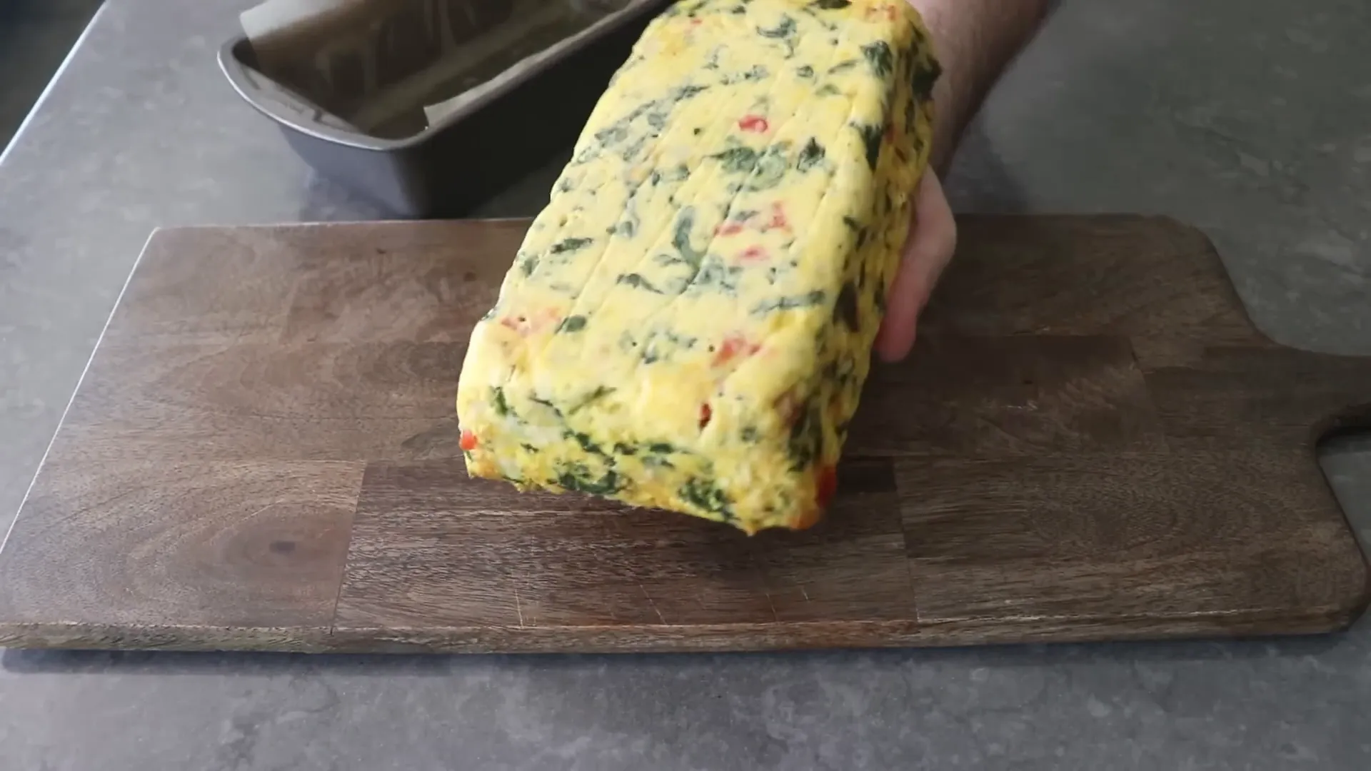 Loaf pan frittata sliding out cleanly with parchment paper