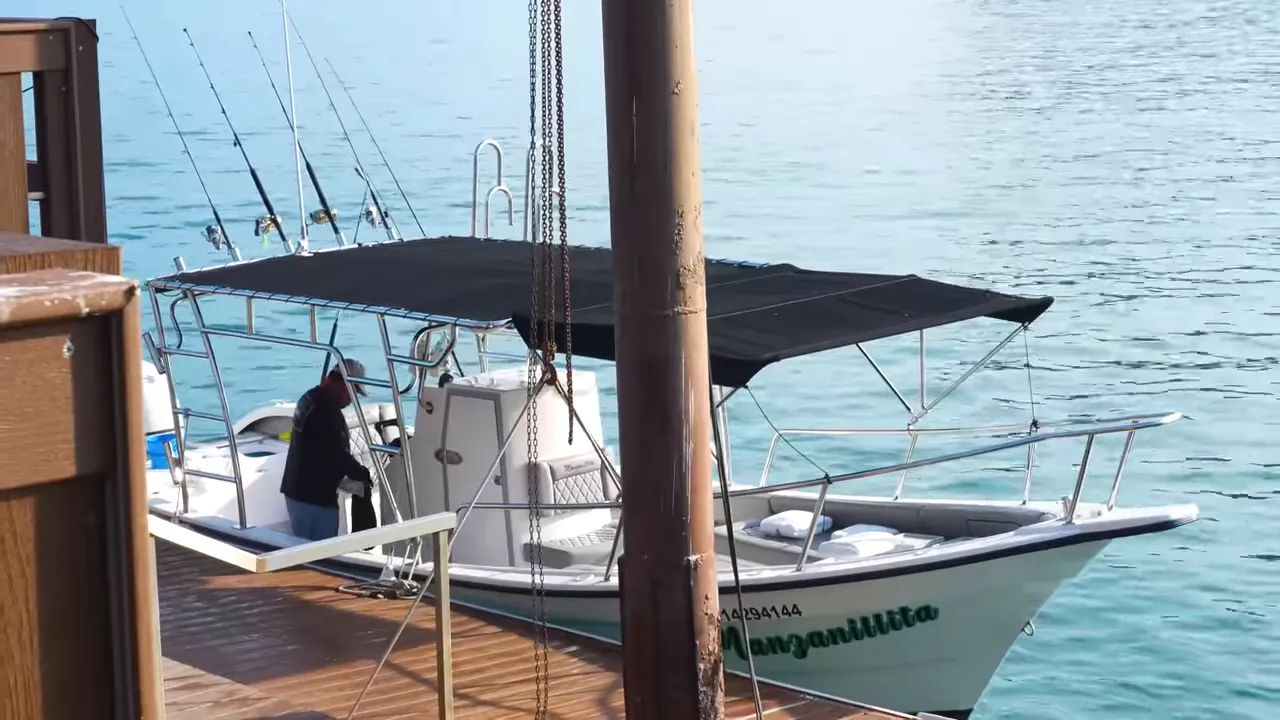 Small fishing boat waiting on the beach at sunrise