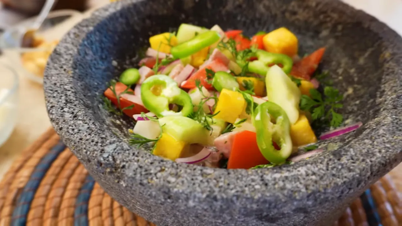 Two plates of ceviche and aguachile served on the beach