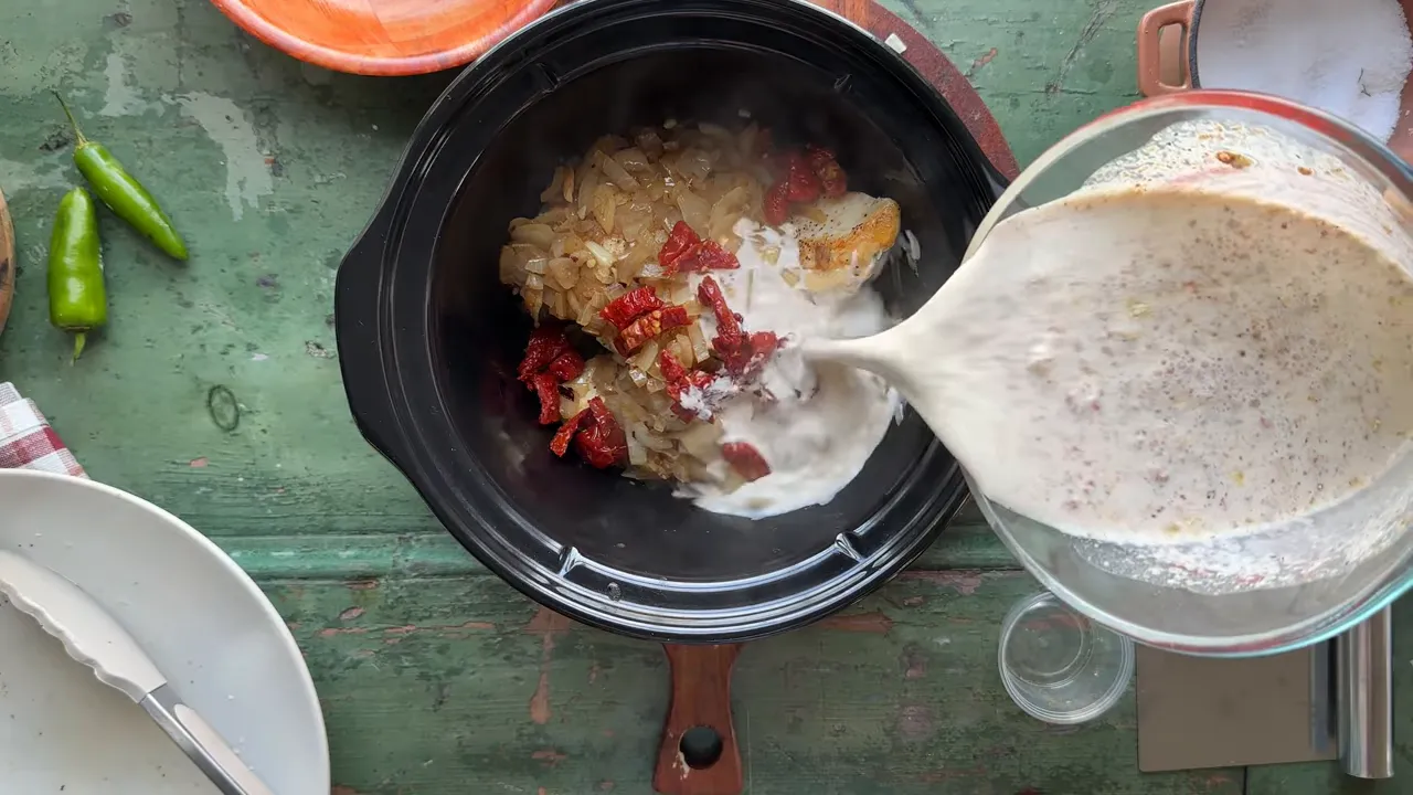Adding sun dried tomatoes and broth mixture to the crock pot