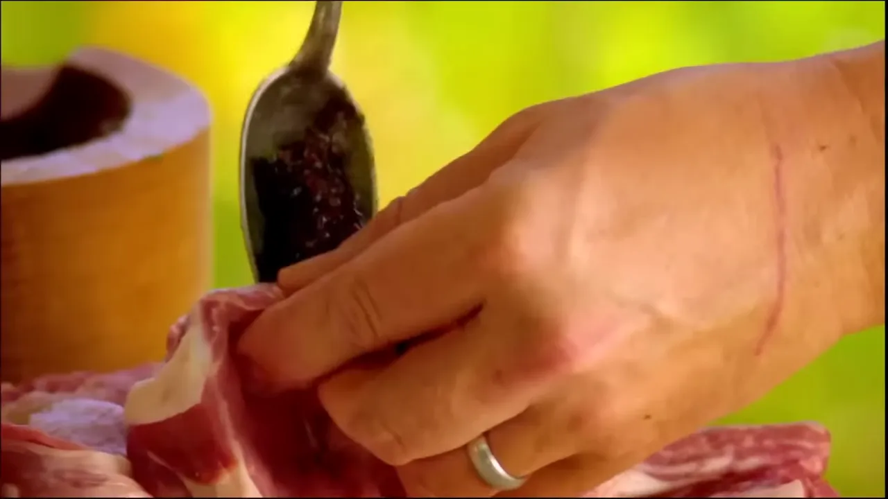 spooning raisin-herb paste into pork pocket