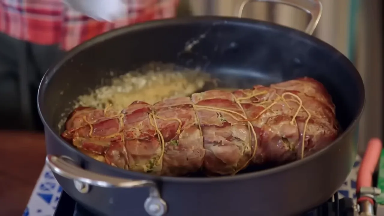 pork loin wrapped in cured ham and tied ready for roasting