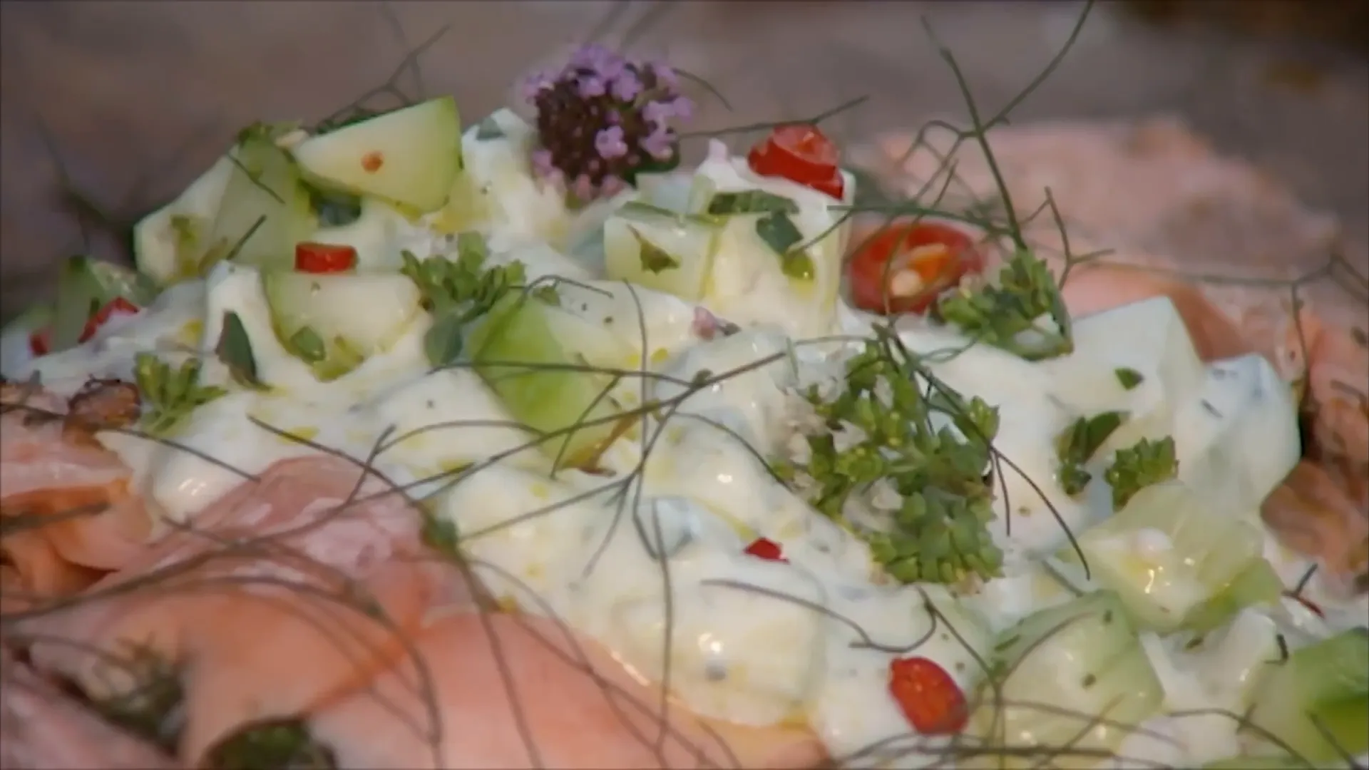 Final plated barbecued salmon with cucumber tzatziki and garnishes