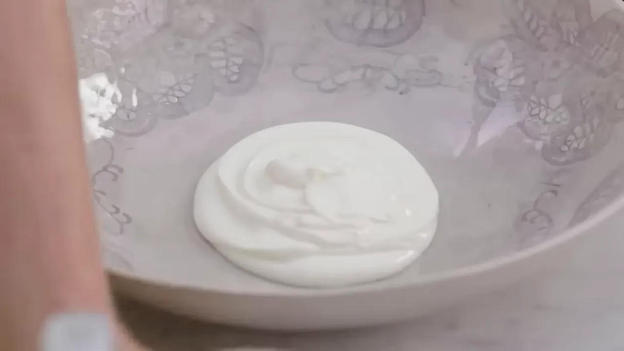 Dollop of plain yogurt in a mixing bowl ready to be whisked into dressing