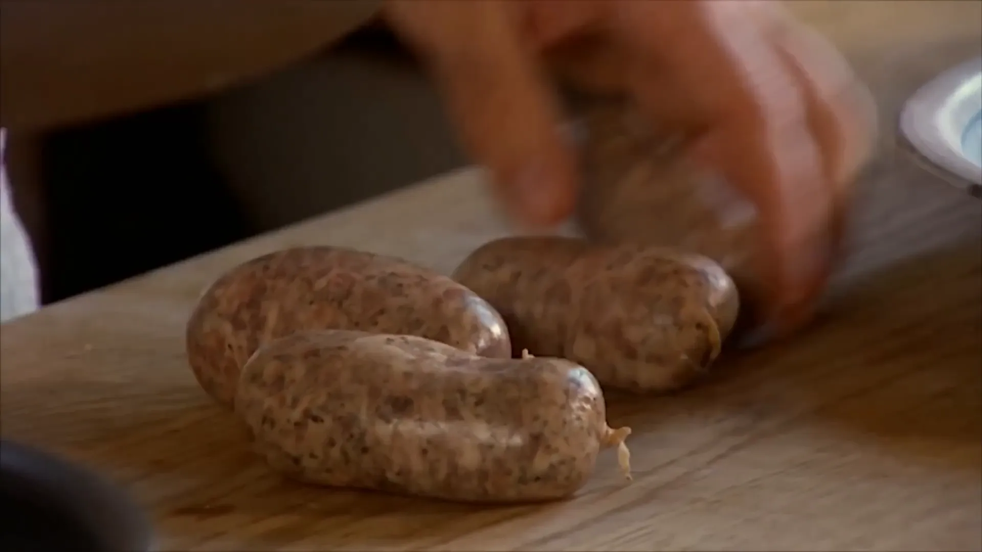 Pinching sausage meat into rustic meatballs