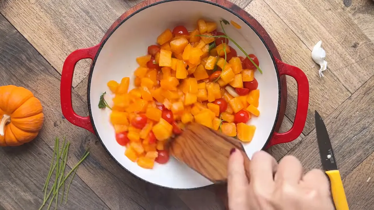 pumpkin and tomatoes simmering in the Dutch oven