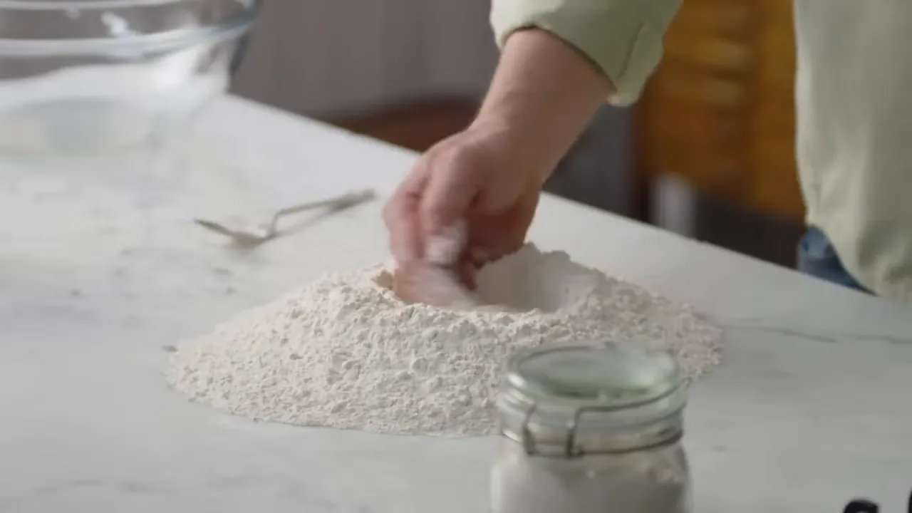 One kilo of strong organic bread flour and measuring jug with tepid water